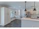 Bright kitchen featuring white cabinets, quartz countertops, stainless steel appliances, and breakfast nook at 12042 S 44Th St, Phoenix, AZ 85044