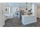Open kitchen flows into living area with stainless steel appliances, white cabinetry, and counter seating at 12042 S 44Th St, Phoenix, AZ 85044