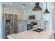 Updated kitchen with quartz counters, stainless appliances, and modern lighting fixtures at 12042 S 44Th St, Phoenix, AZ 85044