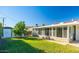 A well-maintained backyard with a shed, lush grass, and a sunroom attached to the house at 12431 N 30Th Ave, Phoenix, AZ 85029