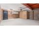 Basement is spacious with brick walls, storage cabinets, and a convenient side door at 12431 N 30Th Ave, Phoenix, AZ 85029