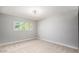 Bright bedroom featuring neutral carpet, a large window, and a simple, comfortable design at 12431 N 30Th Ave, Phoenix, AZ 85029