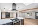 Open-concept living space with a modern kitchen, sleek range hood, and hardwood floors throughout at 12431 N 30Th Ave, Phoenix, AZ 85029