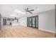 Spacious living room with hardwood floors, recessed lighting, and a stylish kitchen visible in the background at 12431 N 30Th Ave, Phoenix, AZ 85029
