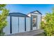 A backyard shed with ample storage space and a door, framed by lush greenery at 12431 N 30Th Ave, Phoenix, AZ 85029