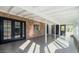 Spacious sunroom with tile floor and brick accents offers ample natural light and access to the outdoors at 12431 N 30Th Ave, Phoenix, AZ 85029