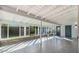 Bright sunroom featuring floor-to-ceiling windows, tile flooring, and a white beamed ceiling, perfect for relaxing at 12431 N 30Th Ave, Phoenix, AZ 85029