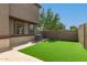 This low-maintenance backyard boasts a green artificial turf lawn, block fence and brick patio at 1255 S Rialto -- # 115, Mesa, AZ 85209