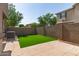 A green backyard features artificial turf and a brick fence for low-maintenance living at 1255 S Rialto -- # 115, Mesa, AZ 85209