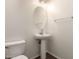 This bathroom features a pedestal sink, oval mirror, and neutral wall paint at 1255 S Rialto -- # 115, Mesa, AZ 85209