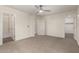 Bedroom featuring a ceiling fan, neutral carpeting, ensuite bath, and walk in closet at 1255 S Rialto -- # 115, Mesa, AZ 85209