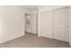 Bedroom featuring neutral colored carpeting, white walls and trim, closet with sliding doors at 1255 S Rialto -- # 115, Mesa, AZ 85209