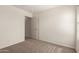 Bedroom featuring neutral colored carpeting, white walls and trim, and a view into the hallway at 1255 S Rialto -- # 115, Mesa, AZ 85209