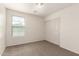 A bedroom featuring a closet with sliding doors, neutral colored carpeting, and a window at 1255 S Rialto -- # 115, Mesa, AZ 85209