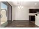 Dining area features a modern chandelier, sliding glass doors, and seamless transition to the kitchen at 1255 S Rialto -- # 115, Mesa, AZ 85209