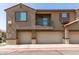 This is the front exterior of the home including two garage doors and a balcony at 1255 S Rialto -- # 115, Mesa, AZ 85209