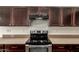 Modern kitchen with stainless steel appliances and stylish dark wood cabinets and granite counters at 1255 S Rialto -- # 115, Mesa, AZ 85209