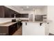 Well-equipped kitchen with stainless steel appliances, granite countertops, and stylish dark wood cabinets at 1255 S Rialto -- # 115, Mesa, AZ 85209