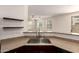 Kitchen sink with granite countertops and bar seating with an open view to the living room at 1255 S Rialto -- # 115, Mesa, AZ 85209