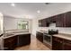 Spacious kitchen features stainless steel appliances, granite countertops and dark wood cabinets at 1255 S Rialto -- # 115, Mesa, AZ 85209