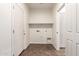 The laundry room is shown with tile floor, overhead shelving, and washer/dryer hookups at 1255 S Rialto -- # 115, Mesa, AZ 85209