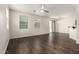 Bright living room featuring hardwood floors, large windows, and a modern ceiling fan at 1255 S Rialto -- # 115, Mesa, AZ 85209