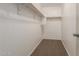 A walk-in closet featuring neutral colored carpet, white walls, and storage shelving at 1255 S Rialto -- # 115, Mesa, AZ 85209