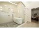 Bathroom featuring a glass shower, soaking tub, tile floors, and access to the main bedroom at 12776 N 78Th St, Scottsdale, AZ 85260