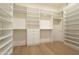 Walk-in closet with custom shelving and drawers for ample storage space at 12776 N 78Th St, Scottsdale, AZ 85260