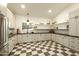 Spacious kitchen featuring custom cabinetry, a stainless steel refrigerator, and stylish checkerboard flooring at 12776 N 78Th St, Scottsdale, AZ 85260