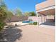 Private backyard featuring a pool, gravel landscaping, covered patio, and a privacy wall offers resort-style living at 1332 E Charleston Ave, Phoenix, AZ 85022