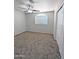 Cozy bedroom with a window, carpet flooring, and a closet for storage at 1332 E Charleston Ave, Phoenix, AZ 85022