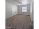 Comfortable bedroom with plush carpeting, closet, window and neutral paint at 1332 E Charleston Ave, Phoenix, AZ 85022