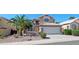 Charming two-story home with desert landscaping, mature palm trees, and a tile roof at 1332 E Charleston Ave, Phoenix, AZ 85022