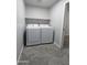 Functional laundry room with new, front loading, washer and dryer and shelving for storage at 1332 E Charleston Ave, Phoenix, AZ 85022