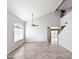 Bright living room with a ceiling fan, vaulted ceilings, and tile floors at 1332 E Charleston Ave, Phoenix, AZ 85022