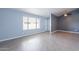 Bright bedroom featuring a ceiling fan, gray accents, large window, and wood-style vinyl flooring at 1402 E Guadalupe Rd # 207, Tempe, AZ 85283