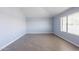 This bedroom has an abundance of natural light from the large window and modern vinyl floors at 1402 E Guadalupe Rd # 207, Tempe, AZ 85283