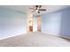 Spacious bedroom features a ceiling fan, plush carpet, and easy access to an adjacent dressing area at 1402 E Guadalupe Rd # 207, Tempe, AZ 85283