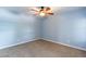Neutral carpet flooring and a ceiling fan provide comfort in this light blue bedroom at 1402 E Guadalupe Rd # 207, Tempe, AZ 85283