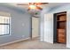 Carpeted bedroom featuring a window and closet with built-in storage at 1402 E Guadalupe Rd # 207, Tempe, AZ 85283