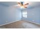 Bright carpeted bedroom with ceiling fan and window at 1402 E Guadalupe Rd # 207, Tempe, AZ 85283