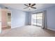Bedroom featuring plush carpet, a ceiling fan, and sliding glass doors to a private patio at 1402 E Guadalupe Rd # 207, Tempe, AZ 85283