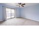 Bedroom featuring a ceiling fan, sliding glass door, plush carpet, and access to a private balcony at 1402 E Guadalupe Rd # 207, Tempe, AZ 85283