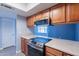 A modern kitchen featuring updated appliances, and classic wood cabinets at 1402 E Guadalupe Rd # 207, Tempe, AZ 85283