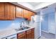 Modern kitchen boasts updated appliances and stainless steel sink beneath wood cabinetry at 1402 E Guadalupe Rd # 207, Tempe, AZ 85283