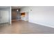 Open-concept living area featuring new wood floors, ceiling fan and a view to kitchen at 1402 E Guadalupe Rd # 207, Tempe, AZ 85283