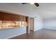 Open concept area with kitchen pass through, ceiling fan, and modern flooring at 1402 E Guadalupe Rd # 207, Tempe, AZ 85283