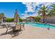 Beautiful community pool with clear water, lounge chairs, tables, and lush landscaping under a sunny sky at 1402 E Guadalupe Rd # 207, Tempe, AZ 85283