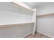 Spacious walk-in closet featuring built-in shelving and ample storage space at 1402 E Guadalupe Rd # 207, Tempe, AZ 85283